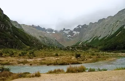 a river running out of a green valley