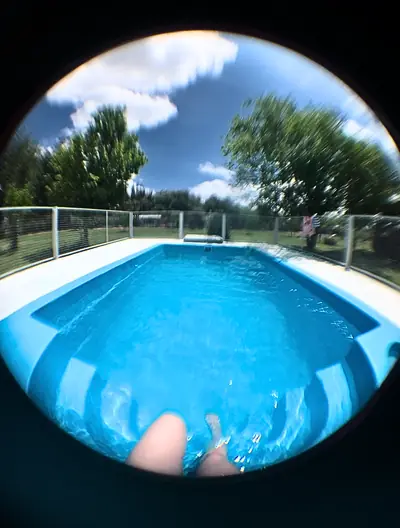 a swimming pool cut into a lawn