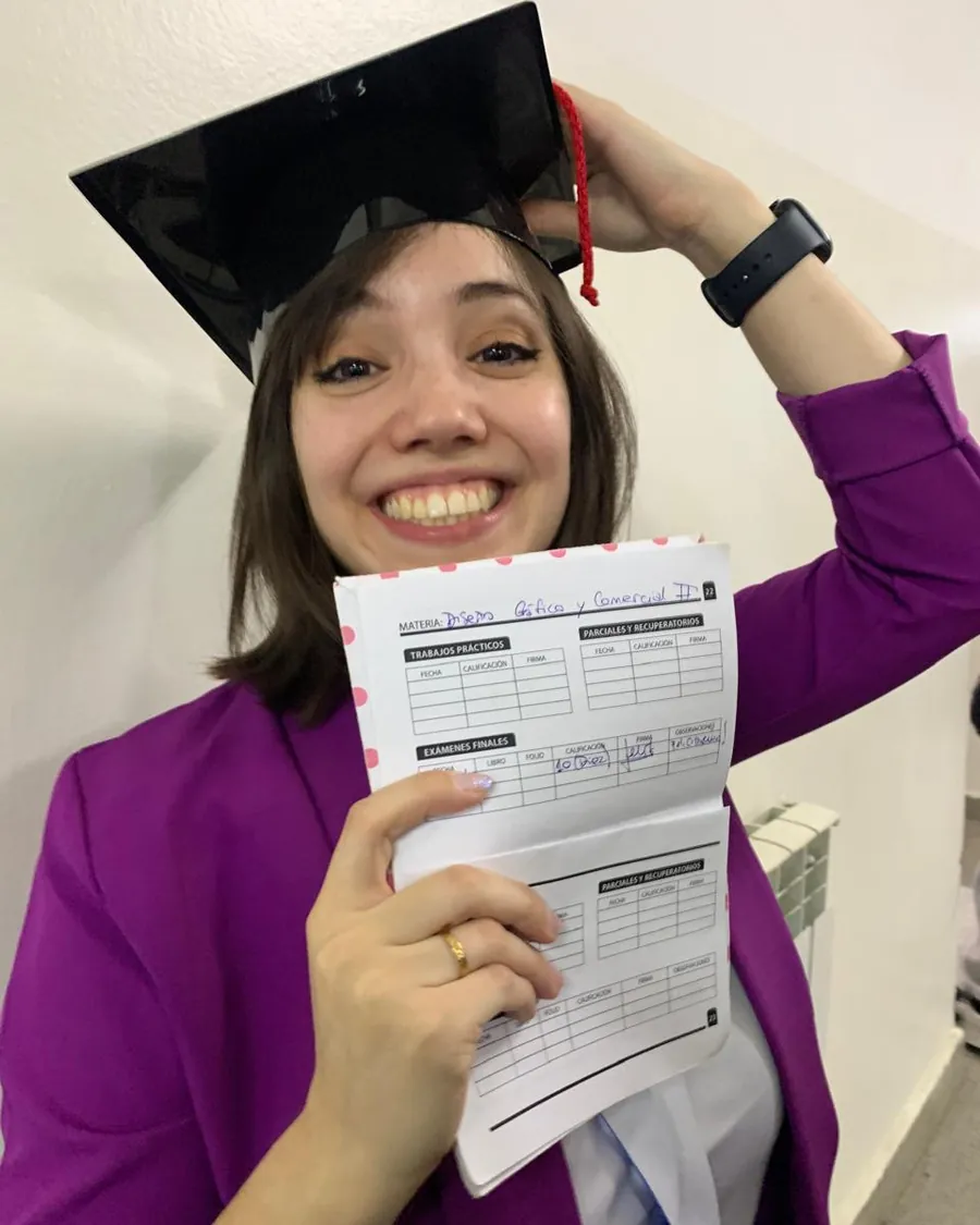 Erica holding open her record book, the final grade written in and signed